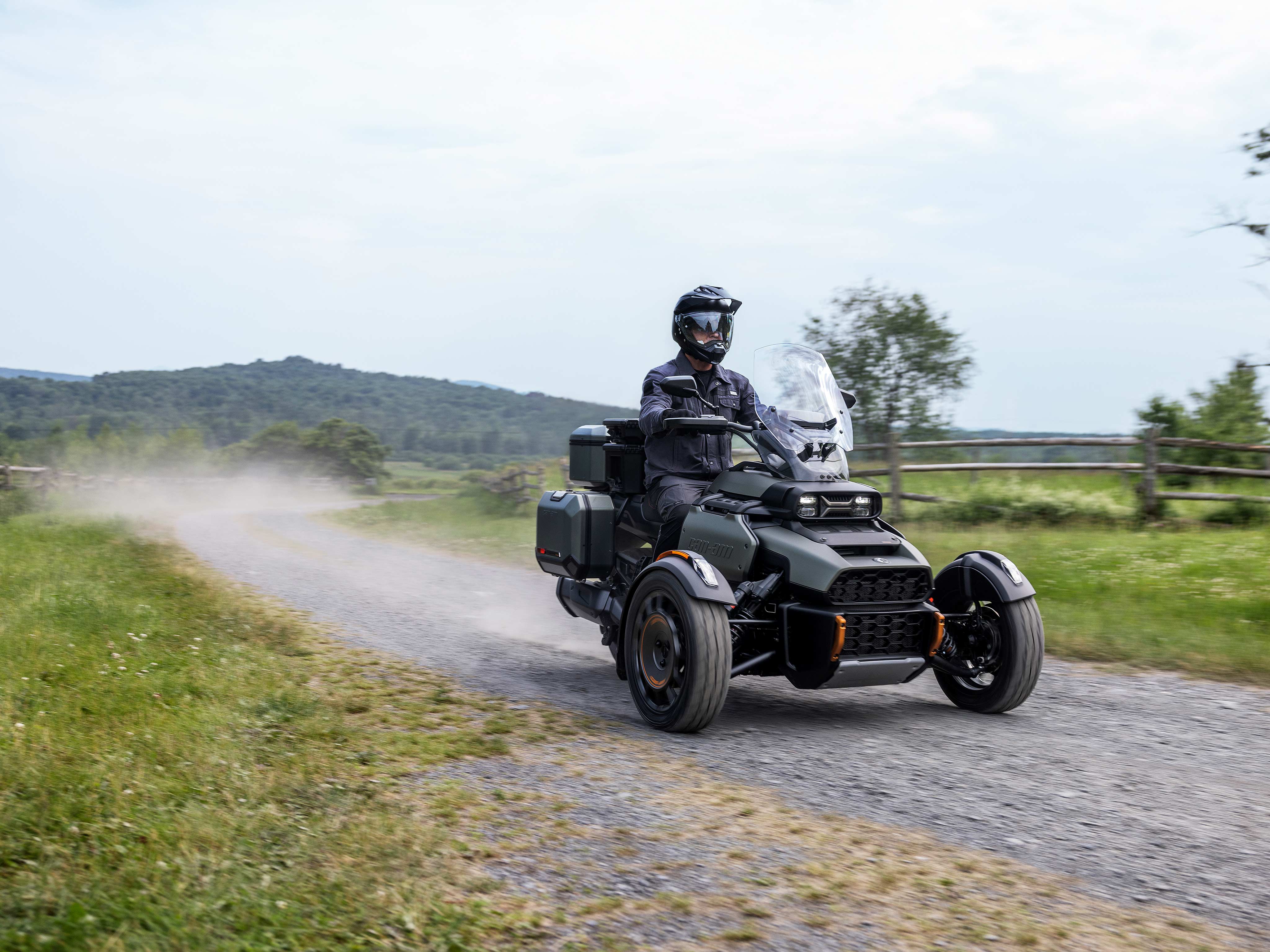 A rider driving a Can-Am Canyon on a gravel road A rider driving a Can-Am Canyon on a gravel road